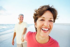 Closeup of a cheerful retired couple having a good time on a beach